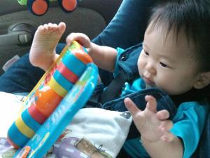 Jaydon awake and playing with his book